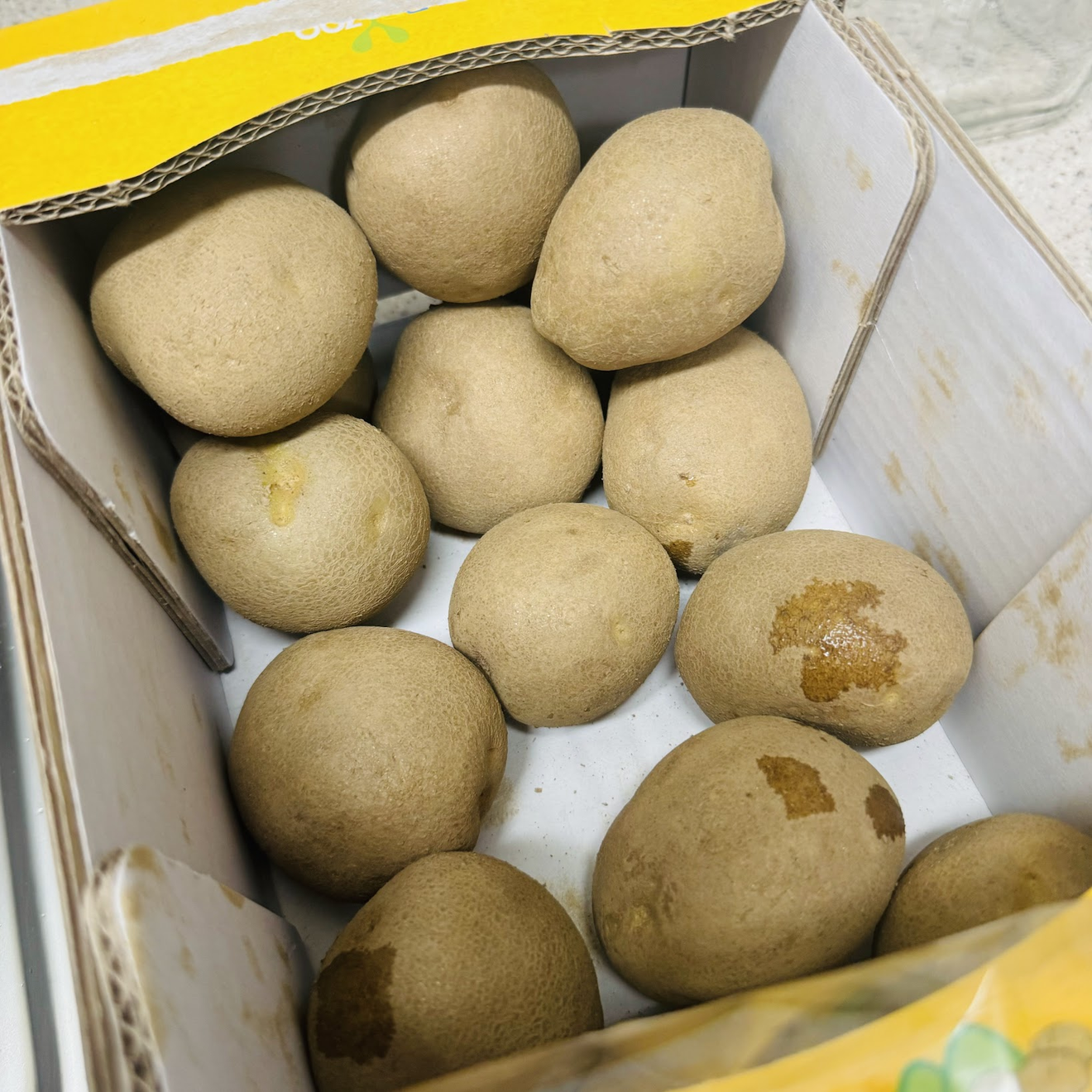 A photo of a box of potatoes